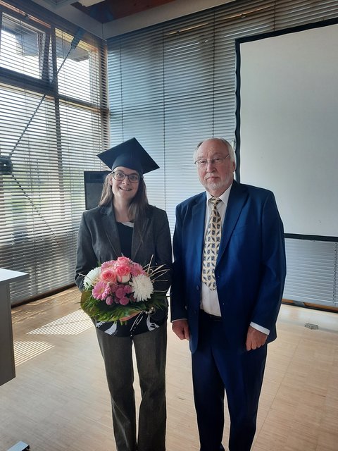 Katharina Göbel mit Doktorhut und Prof. Dr. Gerd Braun nach der erfolgreich bestandenen Disputation am 14.04.2025